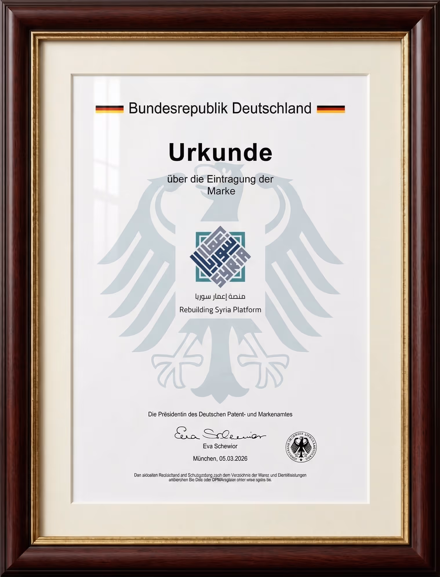 Framed German certificate of trademark registration for Rebuilding Syria Platform with signatures and stamps.